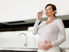 A pregnant woman drinking water