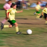 young girl playing soccer