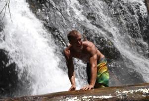 young man in creek waterfall